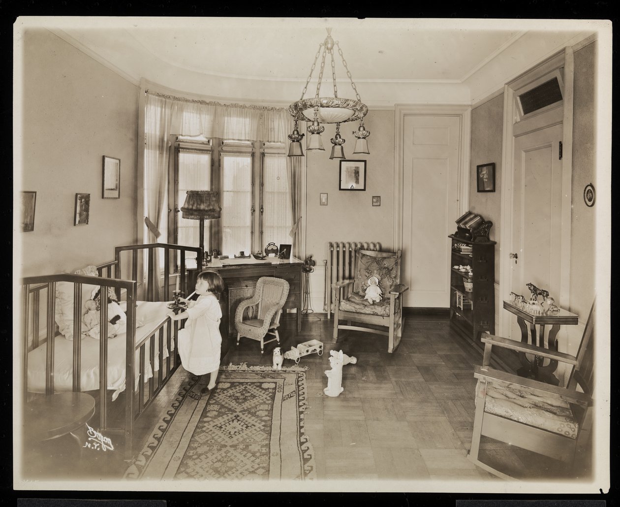 Egy lány, aki gyertyát tart, bemászik egy kiságyba az A.C. Cronin rezidencia hálószobájában, 1915-16 (ezüst zselatin nyomat) alkotó: Byron Company
