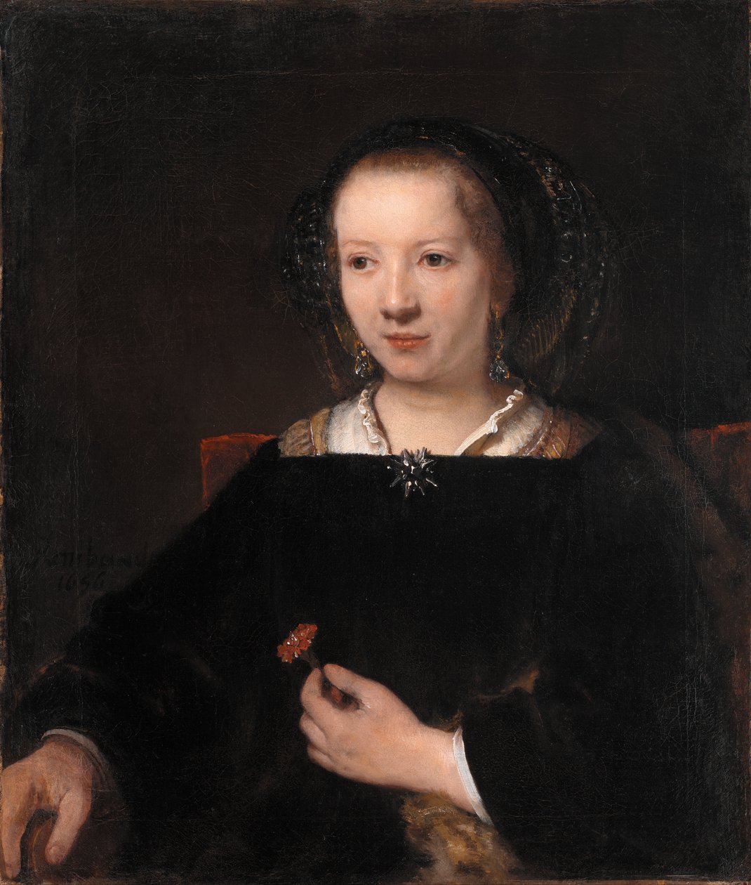 Fiatal nő szegfűvel alkotó: Rembrandt van Rijn